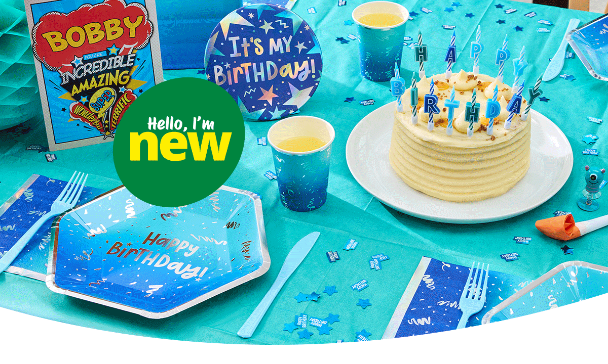 Blue birthday party table with a birthday cake, Happy Birthday candles, themed tableware, confetti, party favours, and birthday decorations.