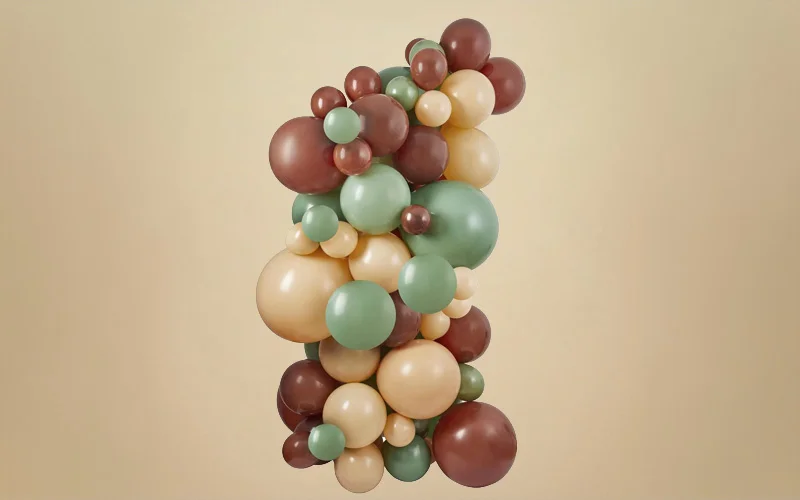 An organic balloon decoration featuring balloons in sage green, cream and mocha brown shades, arranged in a layered cluster of varying sizes against a neutral beige background. The display creates a nature-inspired baby shower decoration with a soft, earthy colour palette. An organic balloon decoration featuring balloons in sage green, cream and mocha brown shades, arranged in a layered cluster of varying sizes against a neutral beige background. The display creates a nature-inspired baby shower decoration with a soft, earthy colour palette.