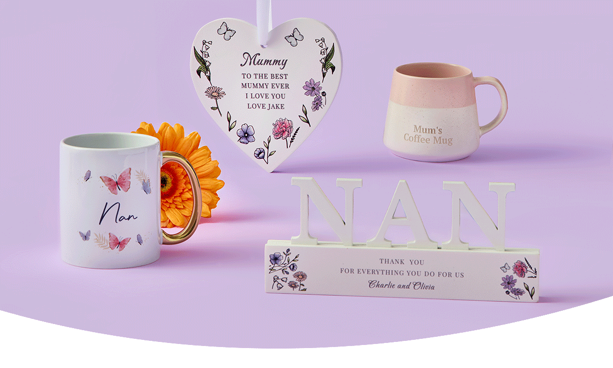 Butterfly‑themed Nan mug, a pink and cream Mum’s coffee mug, a floral heart plaque with a loving message, and a decorative NAN sign arranged together on a pastel purple background. Butterfly‑themed Nan mug, a pink and cream Mum’s coffee mug, a floral heart plaque with a loving message, and a decorative NAN sign arranged together on a pastel purple background.