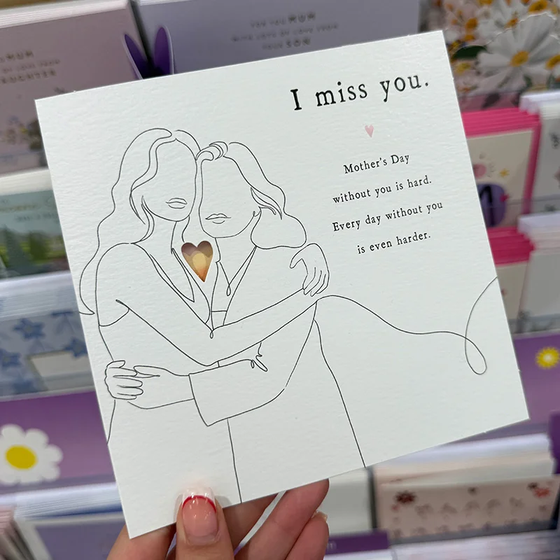 The inside of a greeting card featuring a continuous line drawing of an adult holding a child with heart‑shaped balloons, next to the printed message about appreciation on Mother’s Day.