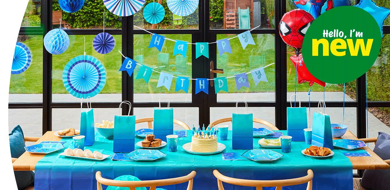Blue birthday party table with a birthday cake, Happy Birthday candles, themed tableware, confetti, party favours, and birthday decorations. Blue birthday party table with a birthday cake, Happy Birthday candles, themed tableware, confetti, party favours, and birthday decorations.