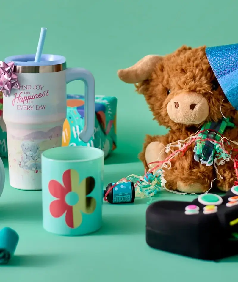 Assorted party gifts and toys including a plush Highland cow, reusable cups, wrapped presents, and colourful celebration accessories. Assorted party gifts and toys including a plush Highland cow, reusable cups, wrapped presents, and colourful celebration accessories.