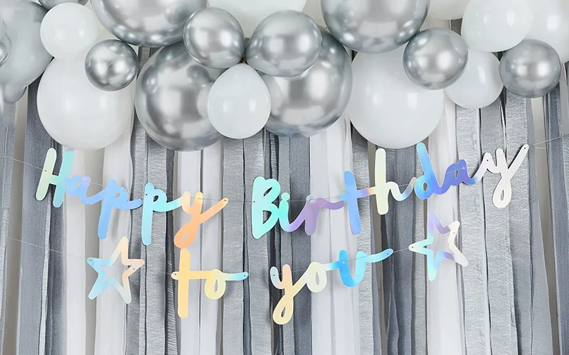 This one feels bright and celebratory. The iridescent Happy Birthday to You banner stands out nicely against the silver and white backdrop. The only thing to watch is that some of the lettering may become less legible at smaller sizes due to the reflective finish. This one feels bright and celebratory. The iridescent Happy Birthday to You banner stands out nicely against the silver and white backdrop. The only thing to watch is that some of the lettering may become less legible at smaller sizes due to the reflective finish.