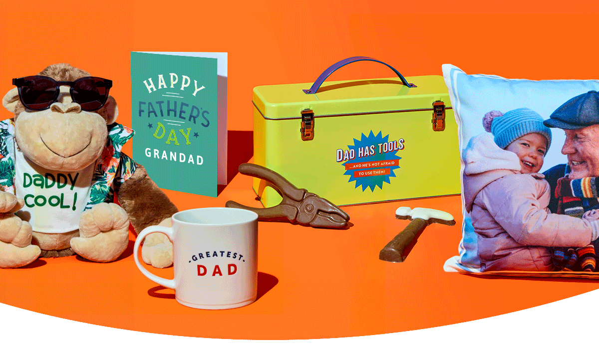 Father’s Day gift display with dad cushion, mug, tool-themed treats, toolbox gift tin, and pint glass arranged on a bright orange background
