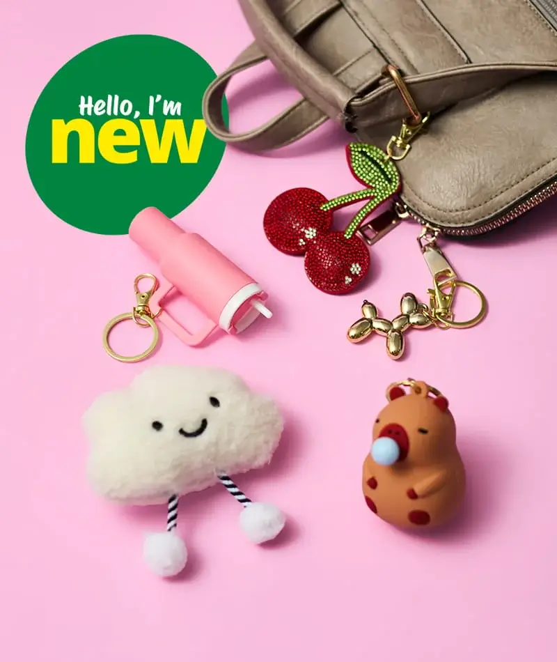New novelty bag charms and keyrings including cherry, cloud, balloon dog, and animal designs displayed beside a handbag on a pink background New novelty bag charms and keyrings including cherry, cloud, balloon dog, and animal designs displayed beside a handbag on a pink background