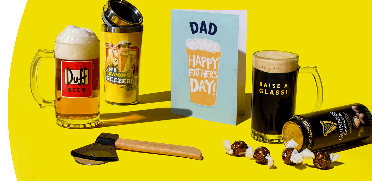 Father’s Day gift selection with beer mugs, a novelty glass, chocolates, tool, and card arranged on a bright yellow background