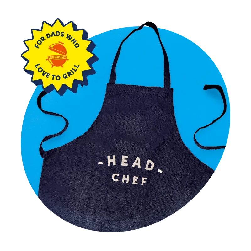 A navy blue cooking apron with white text reading ‘Head Chef,’ displayed against a blue circular background with a yellow badge reading ‘For dads who love to grill. A navy blue cooking apron with white text reading ‘Head Chef,’ displayed against a blue circular background with a yellow badge reading ‘For dads who love to grill.