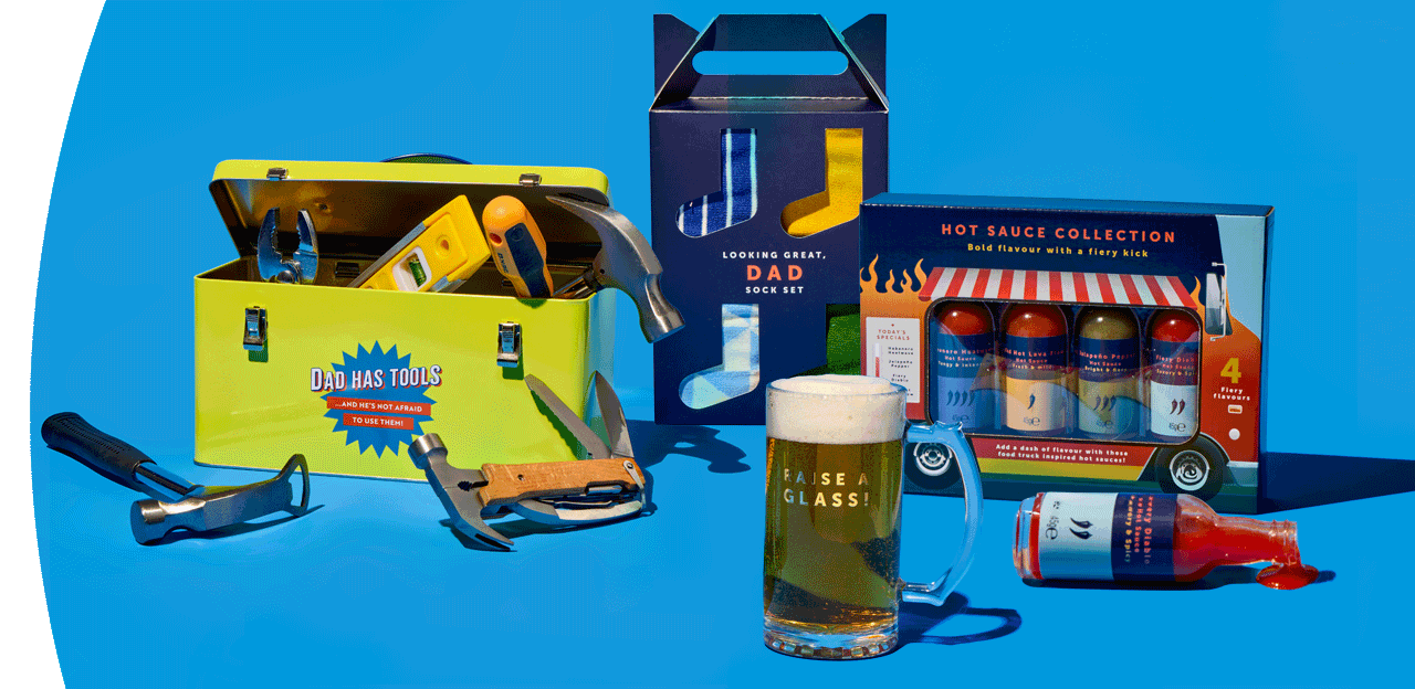 Father’s Day gift set with toolbox tin, tools, hot sauce collection, socks, and a beer mug displayed on a blue background