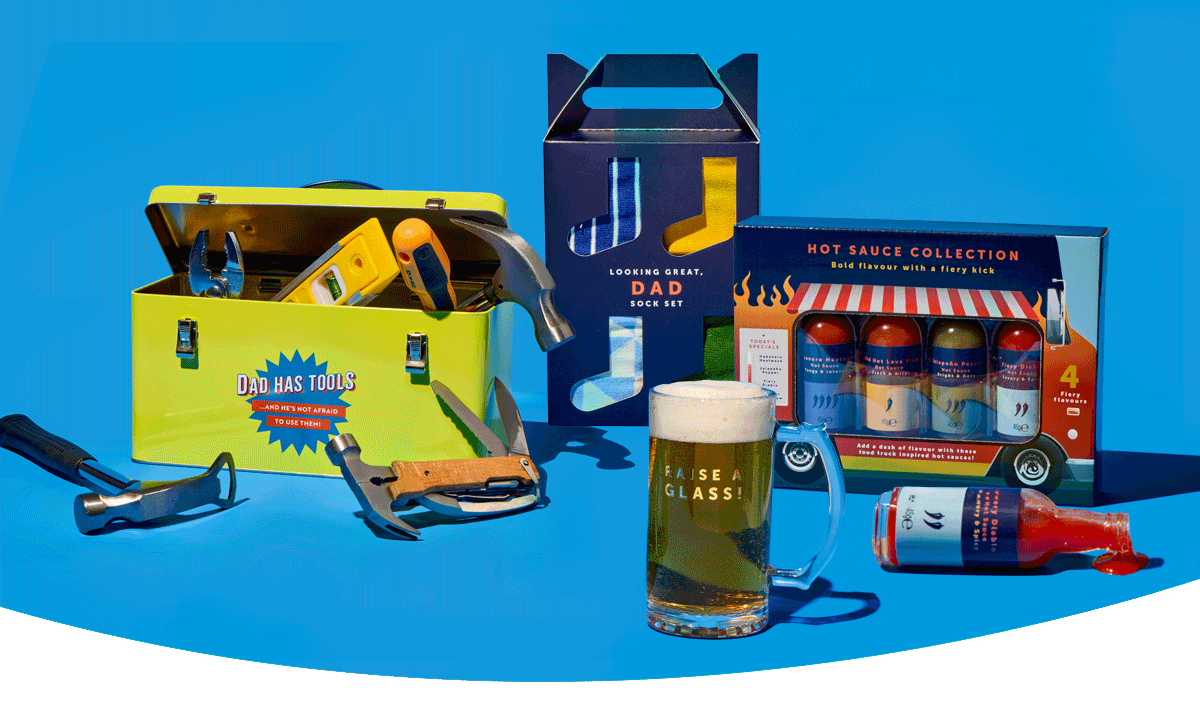 Father’s Day gift set with toolbox tin, tools, hot sauce collection, socks, and a beer mug displayed on a blue background