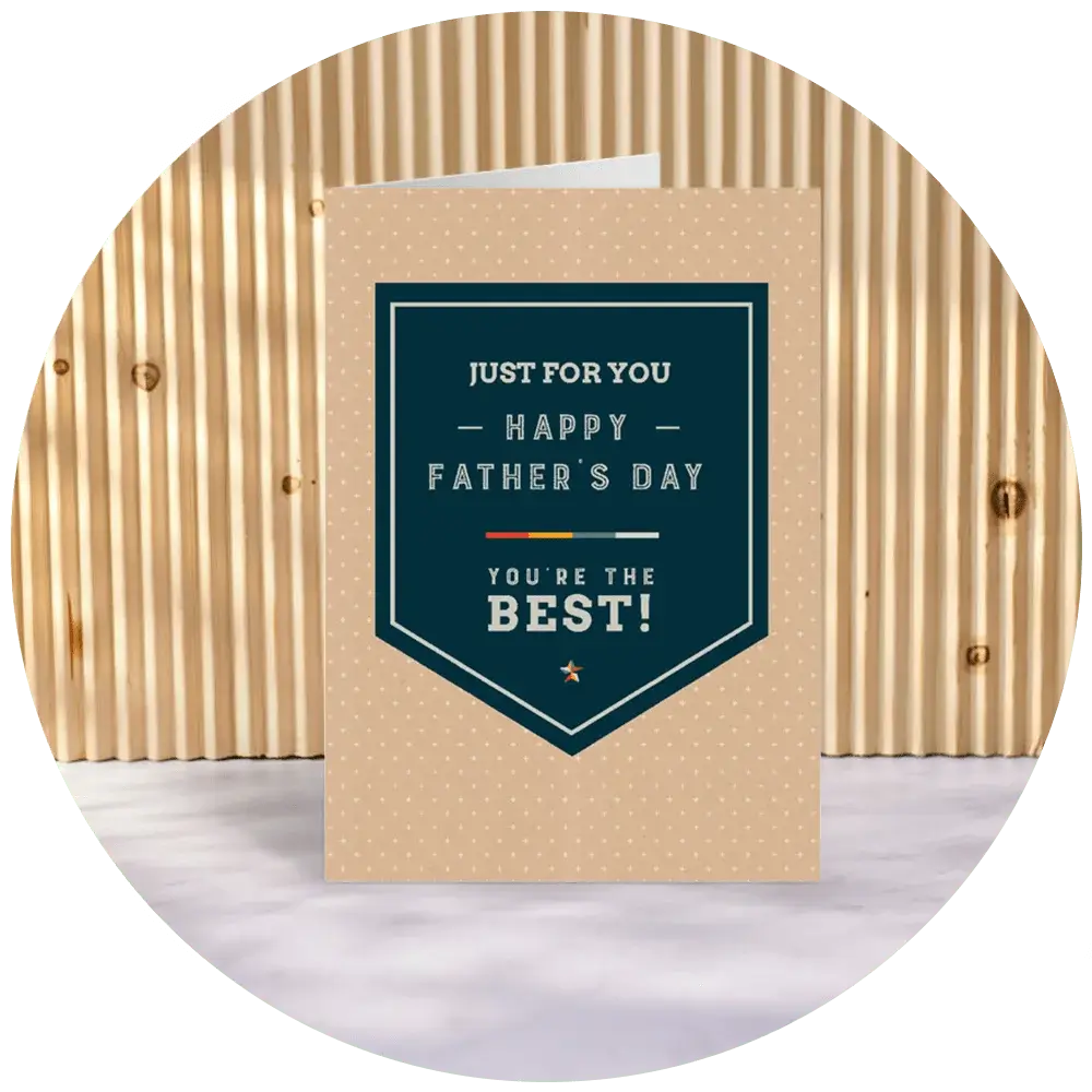 A beige Father’s Day card with a dark green shield‑style panel and dotted pattern, featuring the text ‘Just for you, Happy Father’s Day, You’re the Best,’ displayed upright against a wooden slatted backdrop. A beige Father’s Day card with a dark green shield‑style panel and dotted pattern, featuring the text ‘Just for you, Happy Father’s Day, You’re the Best,’ displayed upright against a wooden slatted backdrop.
