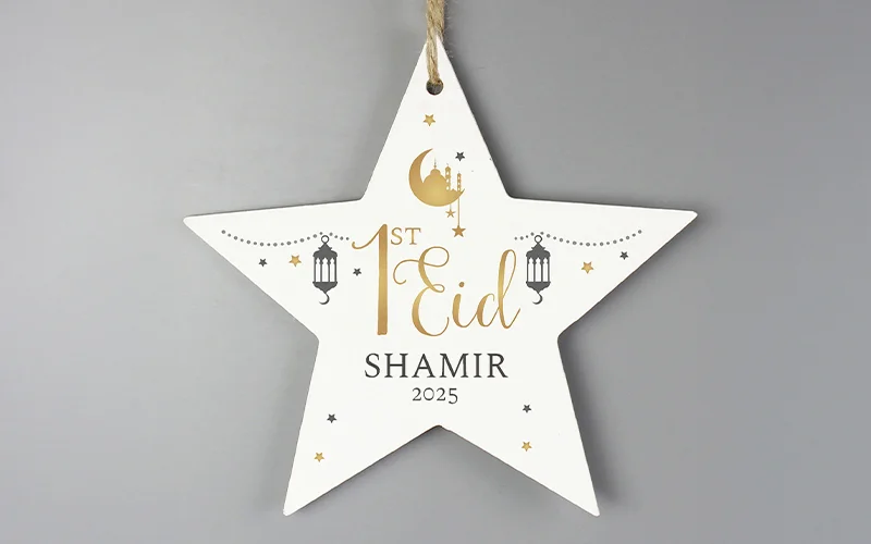 A white star‑shaped hanging ornament decorated with gold crescent moons, stars and lanterns, personalised with the text ‘1st Eid Shamir 2025.’