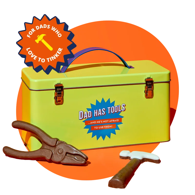 A yellow metal toolbox with a blue handle and clasp printed with the message ‘Dad has tools… and he’s not afraid to use them!,’ displayed alongside chocolate tools shaped like pliers and a hammer, against a bright orange background with a ‘For dads who love to tinker’ badge. A yellow metal toolbox with a blue handle and clasp printed with the message ‘Dad has tools… and he’s not afraid to use them!,’ displayed alongside chocolate tools shaped like pliers and a hammer, against a bright orange background with a ‘For dads who love to tinker’ badge.