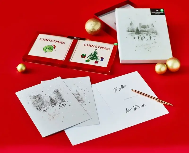 Cozy Christmas scene with personalized pillow, red stocking, plush bunny, maracas, and elf snow globe near a decorated tree.