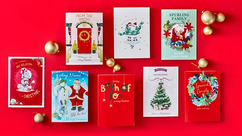 Nine Christmas cards with festive designs including Santa Claus, Christmas trees, and holiday decorations, arranged on a red background with gold ornaments, some cards featuring personalised names and greetings like Merry Christmas and Special Couple.