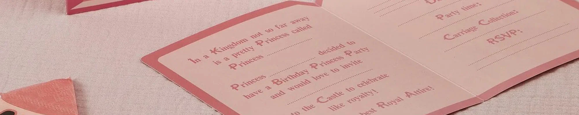 A close-up of an open princess-themed party invitation in shades of pink, featuring a fairytale-style message beginning ‘In a Kingdom not so far away’ and spaces to fill in party details including date, time, collection information and RSVP. A close-up of an open princess-themed party invitation in shades of pink, featuring a fairytale-style message beginning ‘In a Kingdom not so far away’ and spaces to fill in party details including date, time, collection information and RSVP.