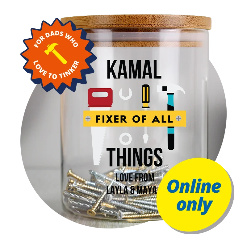A clear glass storage jar with a wooden lid, filled with assorted screws and fixings, featuring a personalised label with tool illustrations and the text ‘Kamal – Fixer of All Things – Love from Layla & Maya,’ displayed against a bright orange background with a badge reading ‘For dads who love to tinker’ and a yellow ‘Online only’ label. A clear glass storage jar with a wooden lid, filled with assorted screws and fixings, featuring a personalised label with tool illustrations and the text ‘Kamal – Fixer of All Things – Love from Layla & Maya,’ displayed against a bright orange background with a badge reading ‘For dads who love to tinker’ and a yellow ‘Online only’ label.