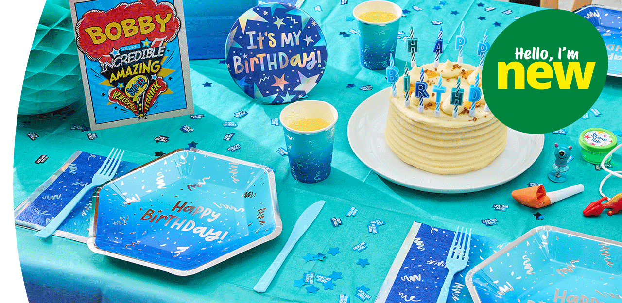 Blue birthday party table with a birthday cake, Happy Birthday candles, themed tableware, confetti, party favours, and birthday decorations.