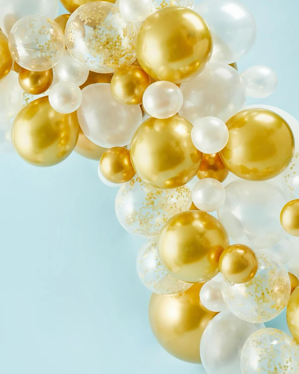 A close-up section of a luxury balloon arch featuring metallic gold, pearl white and clear balloons filled with gold confetti, arranged in varying sizes to create a layered organic design. The balloon garland is displayed against a pale blue background, showcasing the finished decorative effect of a gold and white balloon arch. A close-up section of a luxury balloon arch featuring metallic gold, pearl white and clear balloons filled with gold confetti, arranged in varying sizes to create a layered organic design. The balloon garland is displayed against a pale blue background, showcasing the finished decorative effect of a gold and white balloon arch.