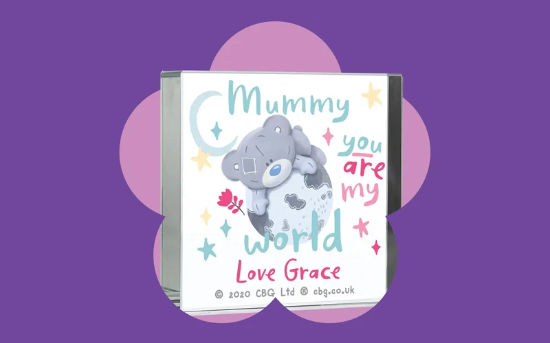 A square Me to You ornament featuring a Tatty Teddy illustration and the message ‘Mummy you are my world, love Grace,’ shown against a purple background with a pink flower shape.