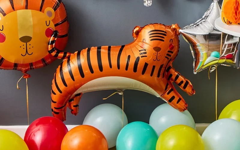 This is probably the strongest from an impact perspective. The tiger foil balloon immediately grabs attention, and the bright colours give it a fun, energetic feel. It clearly communicates a children's party theme and would work well as a hero image. This is probably the strongest from an impact perspective. The tiger foil balloon immediately grabs attention, and the bright colours give it a fun, energetic feel. It clearly communicates a children's party theme and would work well as a hero image.