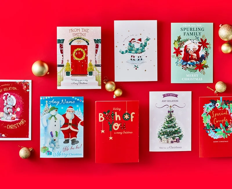 Nine Christmas cards with festive designs including Santa Claus, Christmas trees, and holiday decorations, arranged on a red background with gold ornaments, some cards featuring personalised names and greetings like Merry Christmas and Special Couple.