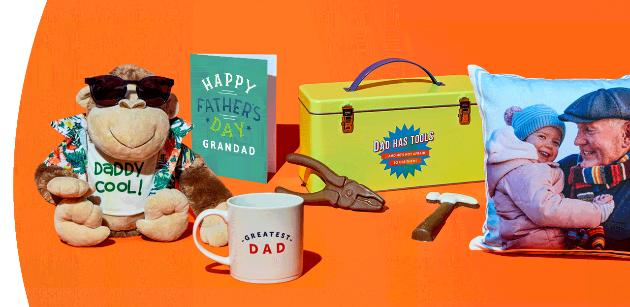 Father’s Day gift display with dad cushion, mug, tool-themed treats, toolbox gift tin, and pint glass arranged on a bright orange background