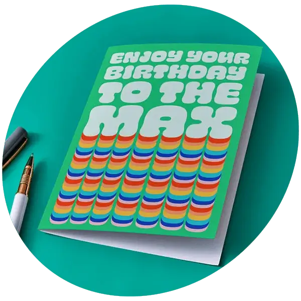 Green birthday card with bold retro text reading Enjoy Your Birthday to the Max with rainbow stripes design
