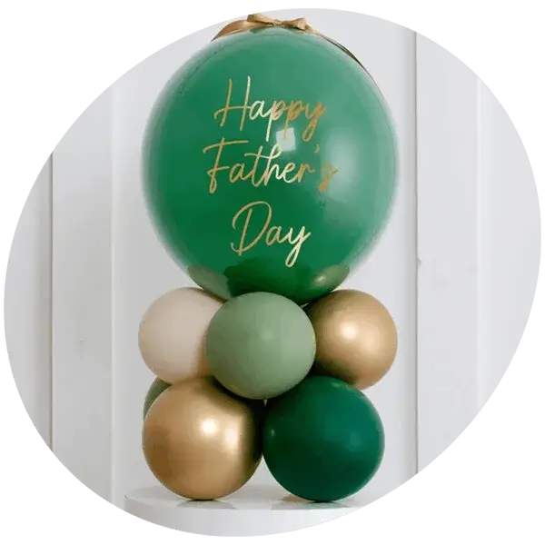 Green and gold Father’s Day balloon arrangement with a large balloon reading Happy Father’s Day on a white background