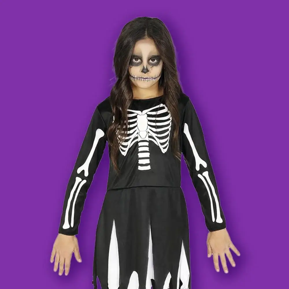 Child’s Halloween skeleton costume with bone-print dress and matching skeleton face paint against a purple background.