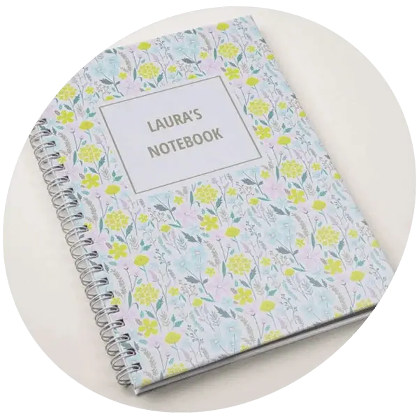 Personalised floral spiral notebook with a pastel wildflower design and custom name on the cover.