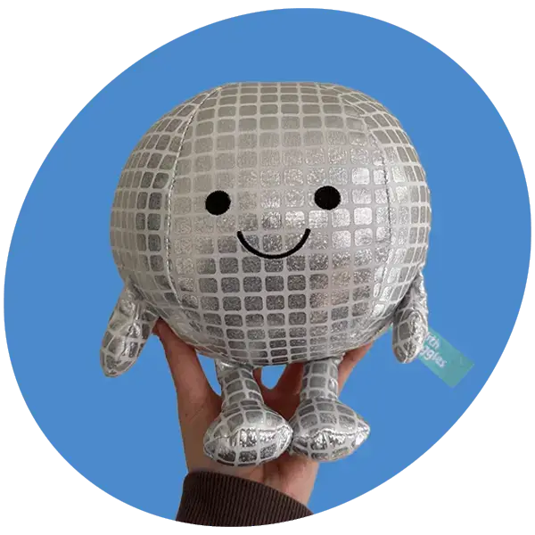 Silver disco ball soft toy with a smiling face and dangling arms and legs, held against a blue background.