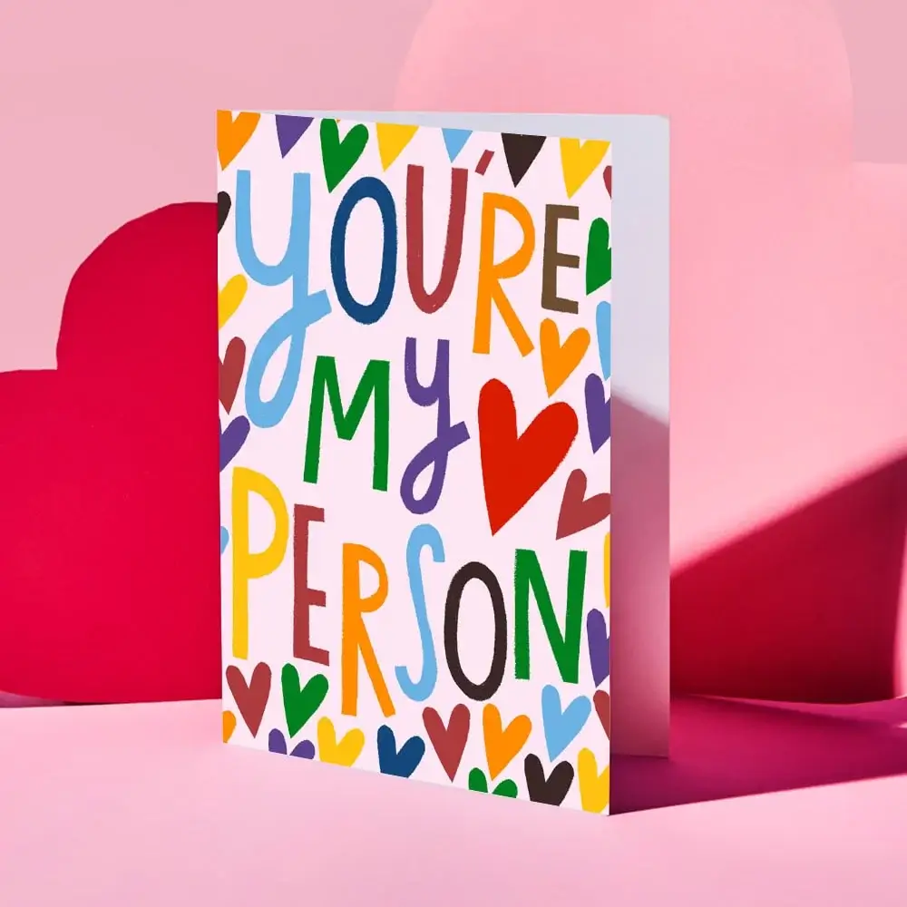 Valentine’s Day card featuring a collage of four romantic couple photos outdoors, decorated with red and gold hearts and the text “Your message here” and “Happy Valentine’s Day” in elegant script