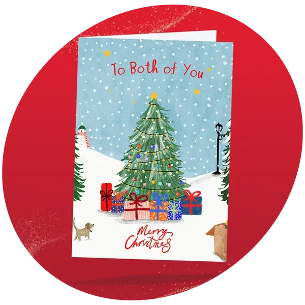 Christmas card showing a snowy scene with a decorated tree, wrapped presents, a small dog, and falling snowflakes, featuring the text To Both of You at the top and Merry Christmas at the bottom.