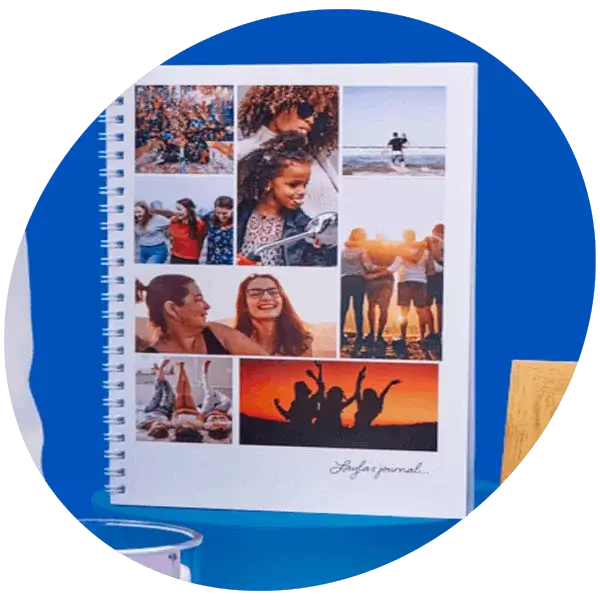 Spiral-bound photo notebook with a collage of group and outdoor snapshots on a blue background
