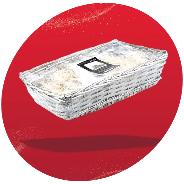 Rectangular white wicker hamper tray with shredded paper filler and a price tag, displayed against a red background with a glitter effect.