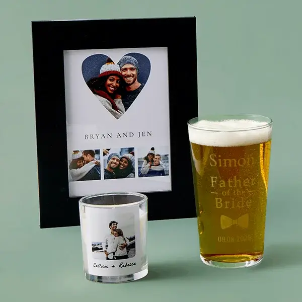 Personalised wedding gift set featuring a photo frame, engraved pint glass, and photo candle displayed on a soft green background.