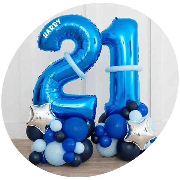 Blue number 21 foil balloons with matching blue and silver balloon clusters arranged on a wooden floor against a white background