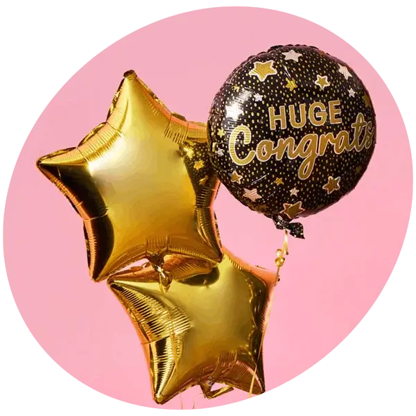 Gold star-shaped balloons and a black congratulations balloon with star pattern displayed on a soft pink background