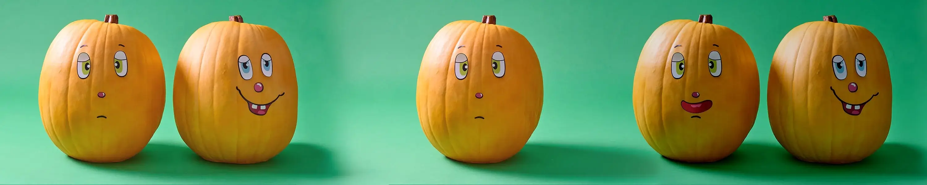 Two painted pumpkins on a green background, one with a sad face and one with a happy, smiling face.