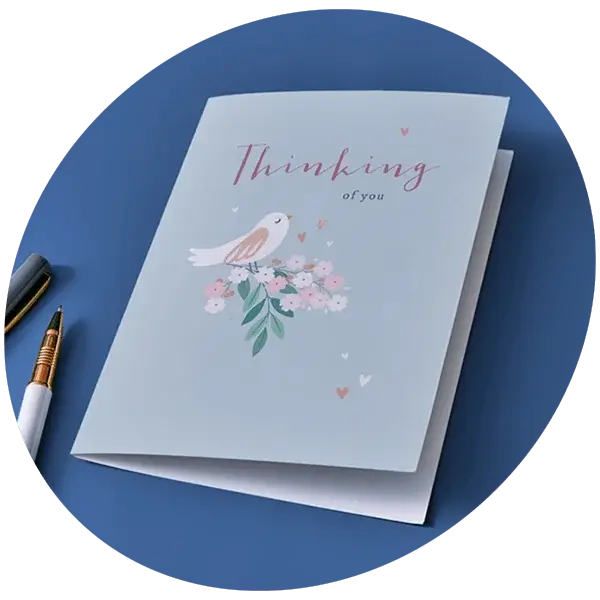 Thinking of You greeting card featuring a bird illustration, floral bouquet, and pastel blue design.
