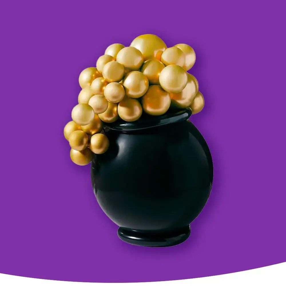 A black vase overflowing with shiny gold spheres of different sizes, set against a purple background