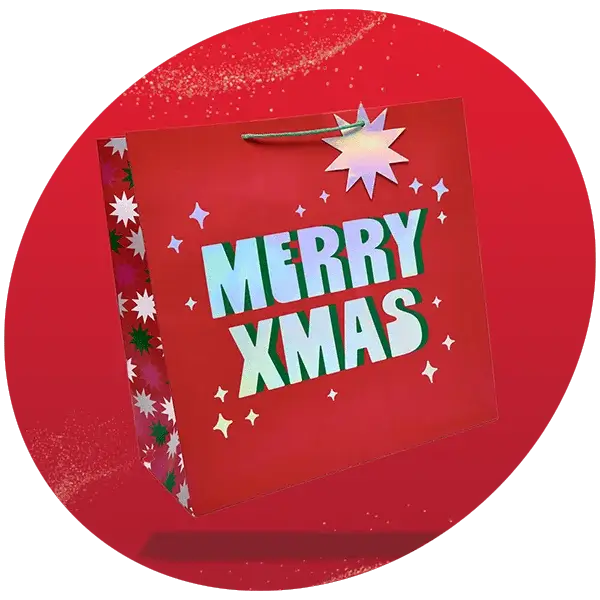 Red gift bag with bold MERRY XMAS text, decorated with white stars, a large starburst at the top, and patterned sides featuring red, green, and white stars.