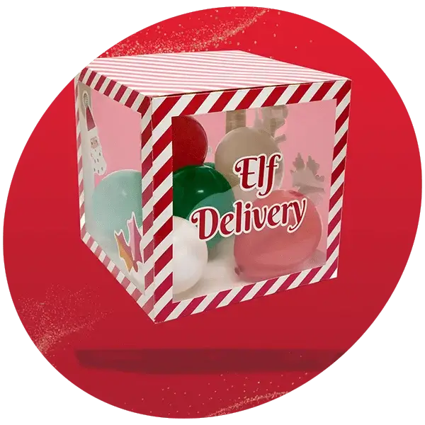 A festive cube-shaped gift box with red and white striped edges, transparent sides, and colorful balloons inside. The front panel displays the text Elf Delivery in bold red letters. The background is solid red with a subtle glitter effect.
