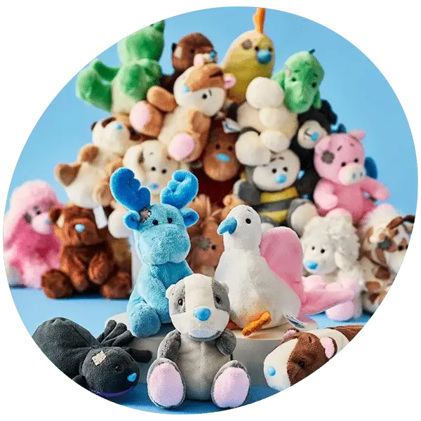 Colorful plush toys including a blue moose, white bird with pink wings, and several bears arranged in a pyramid formation against a light blue background. Colorful plush toys including a blue moose, white bird with pink wings, and several bears arranged in a pyramid formation against a light blue background.