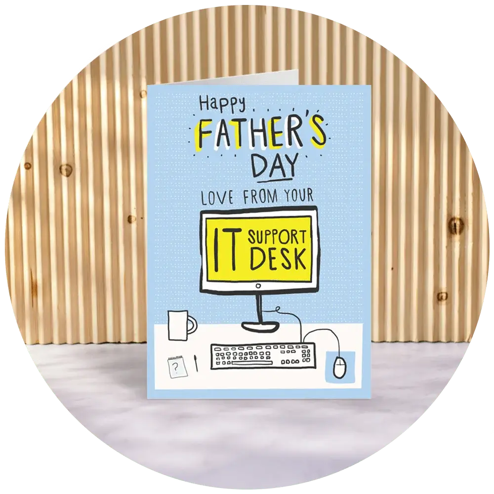 A greeting card with a light blue background and a computer-themed design. The text on the card reads 'Happy Father's Day Love from your IT Support Desk'. The illustration includes a computer monitor displaying the words 'IT Support Desk', a keyboard, a mouse, and a coffee mug. A greeting card with a light blue background and a computer-themed design. The text on the card reads 'Happy Father's Day Love from your IT Support Desk'. The illustration includes a computer monitor displaying the words 'IT Support Desk', a keyboard, a mouse, and a coffee mug.