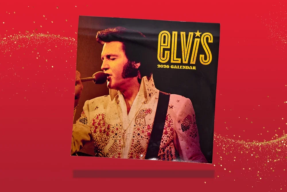 A 2026 Elvis calendar featuring a performance image of Elvis Presley in a white embellished outfit, set against a red background with gold sparkles. A 2026 Elvis calendar featuring a performance image of Elvis Presley in a white embellished outfit, set against a red background with gold sparkles.