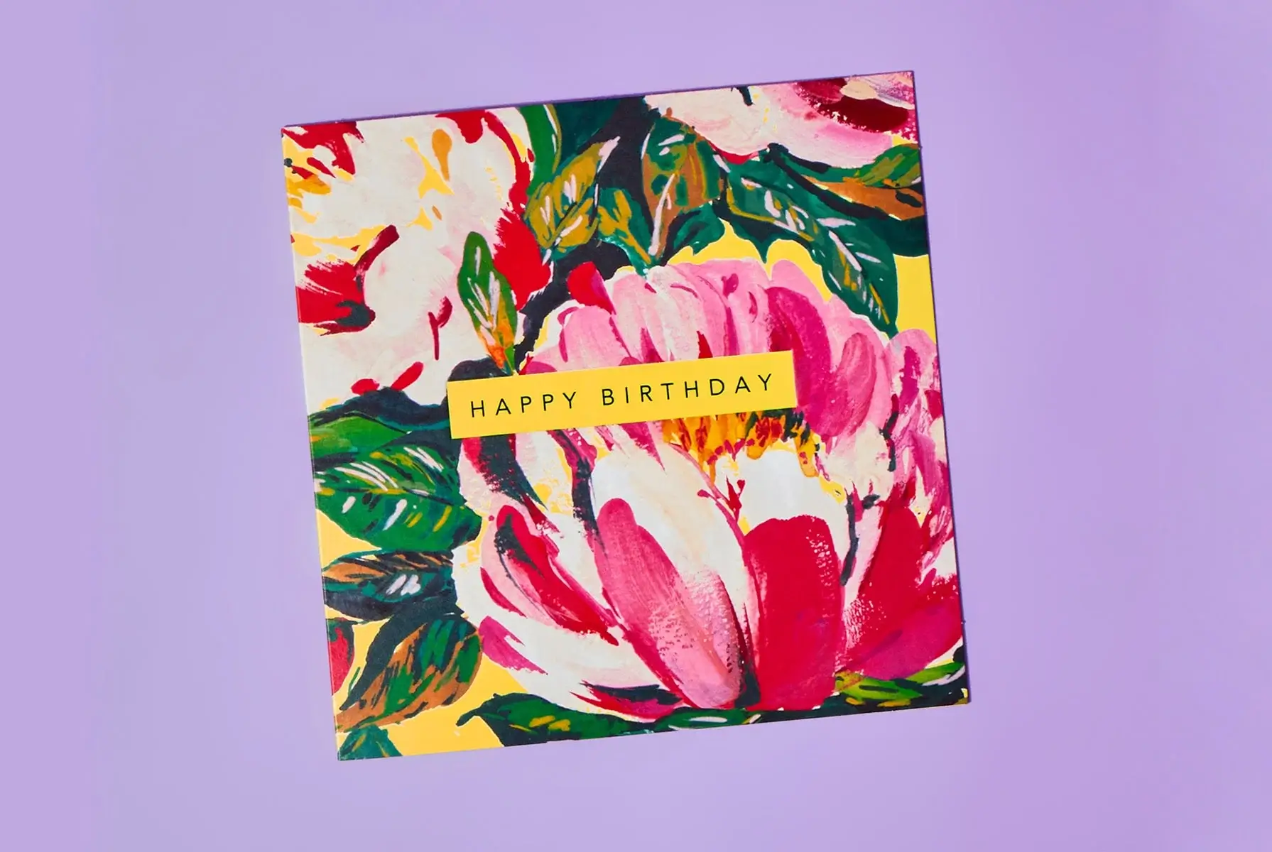 'A square birthday card with a vibrant floral design featuring large pink and red flowers with green leaves on a yellow background. The card has a yellow rectangular label in the center with the text 'HAPPY BIRTHDAY' in uppercase letters.' 'A square birthday card with a vibrant floral design featuring large pink and red flowers with green leaves on a yellow background. The card has a yellow rectangular label in the center with the text 'HAPPY BIRTHDAY' in uppercase letters.'