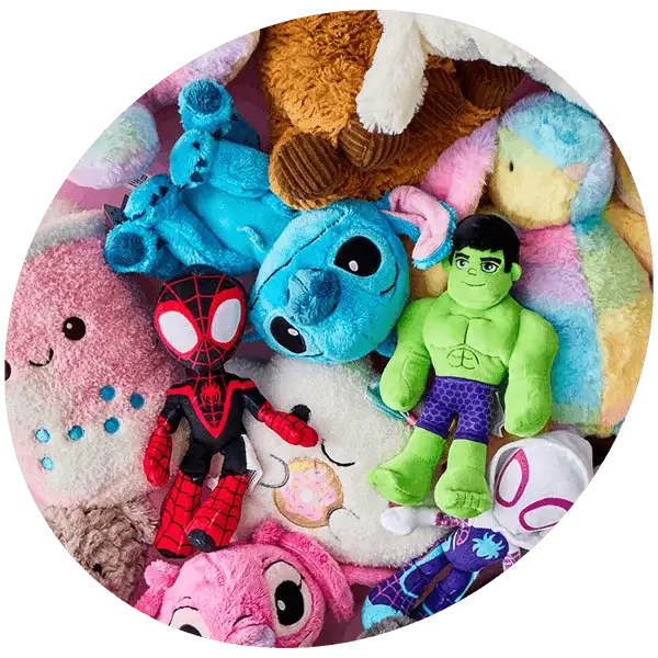 A pile of colorful plush toys featuring various characters, including superheroes and animated creatures.