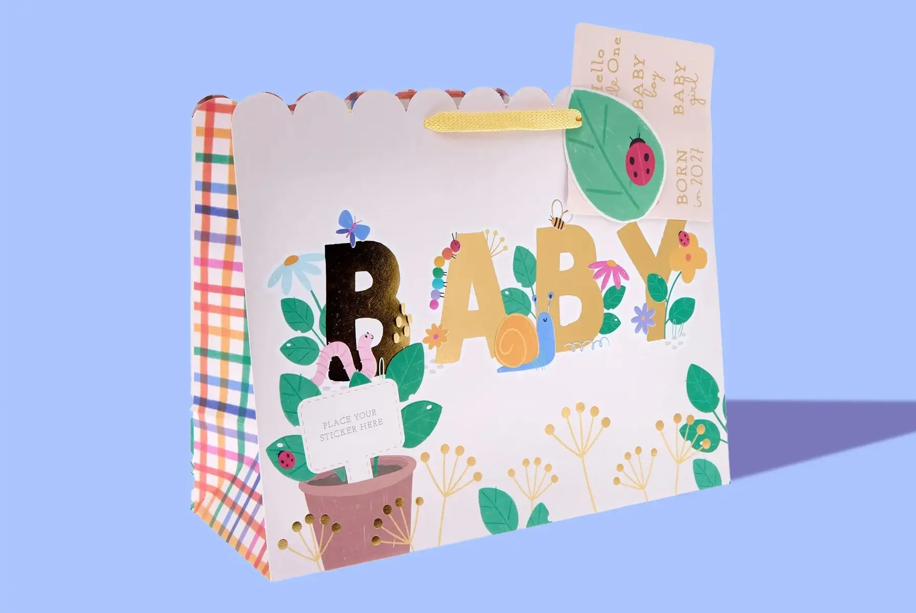 ''A colorful gift bag with the word 'BABY' in large, decorated letters. The bag features various plants, flowers, and a snail illustration. There is a small card attached to the handle that reads 'Hello Little One', 'BABY', and 'BORN 2021'. The sides of the bag have a checkered pattern.' 'A colorful gift bag with the word 'BABY' in large, decorated letters. The bag features various plants, flowers, and a snail illustration. There is a small card attached to the handle that reads 'Hello Little One', 'BABY', and 'BORN 2021'. The sides of the bag have a checkered pattern.'
