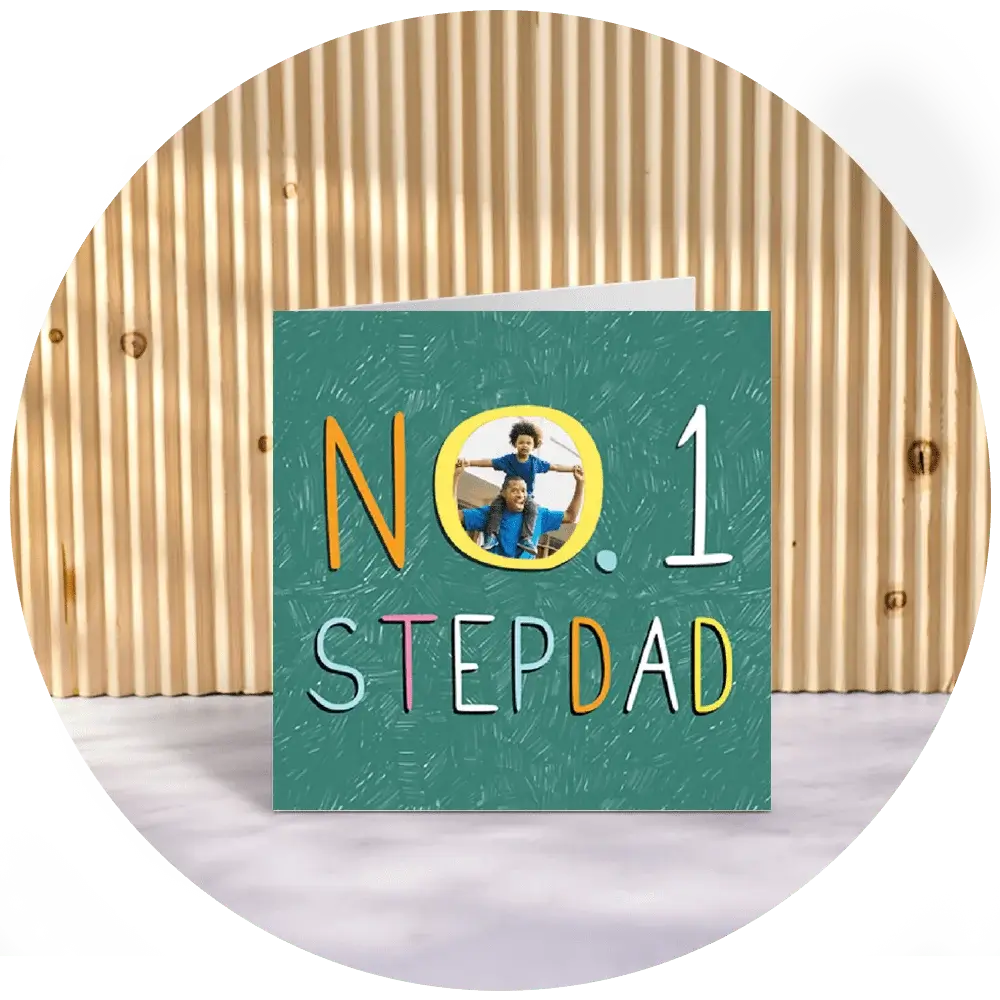 A greeting card with a green background and the text 'NO. 1 STEP DAD' in colorful letters. The letter 'O' in 'NO.' is replaced by a circular photo of a man holding two children. A greeting card with a green background and the text 'NO. 1 STEP DAD' in colorful letters. The letter 'O' in 'NO.' is replaced by a circular photo of a man holding two children.